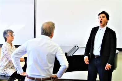 Masterclass with singer performing next to piano, accompanist and teacher